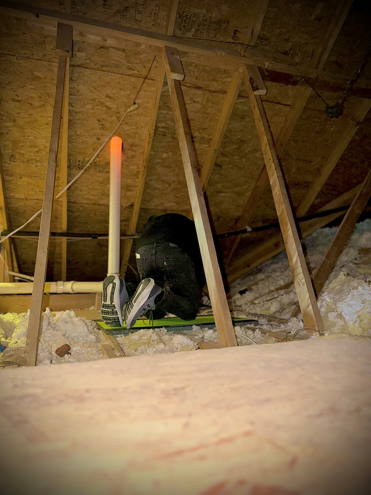 insulation technician using atticboard to work in an attic