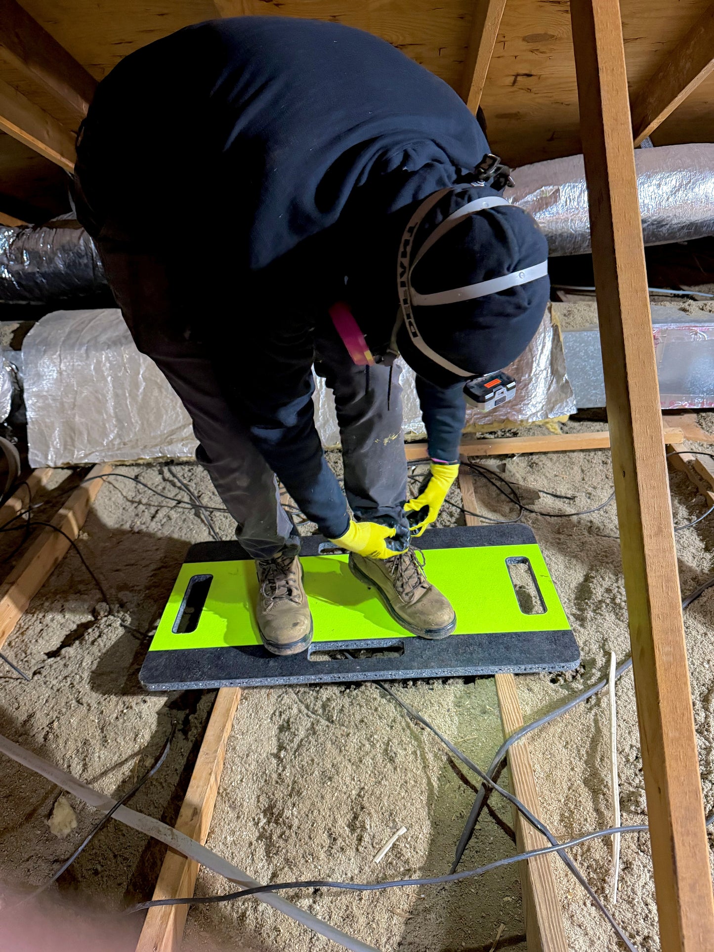 person working on an attic board