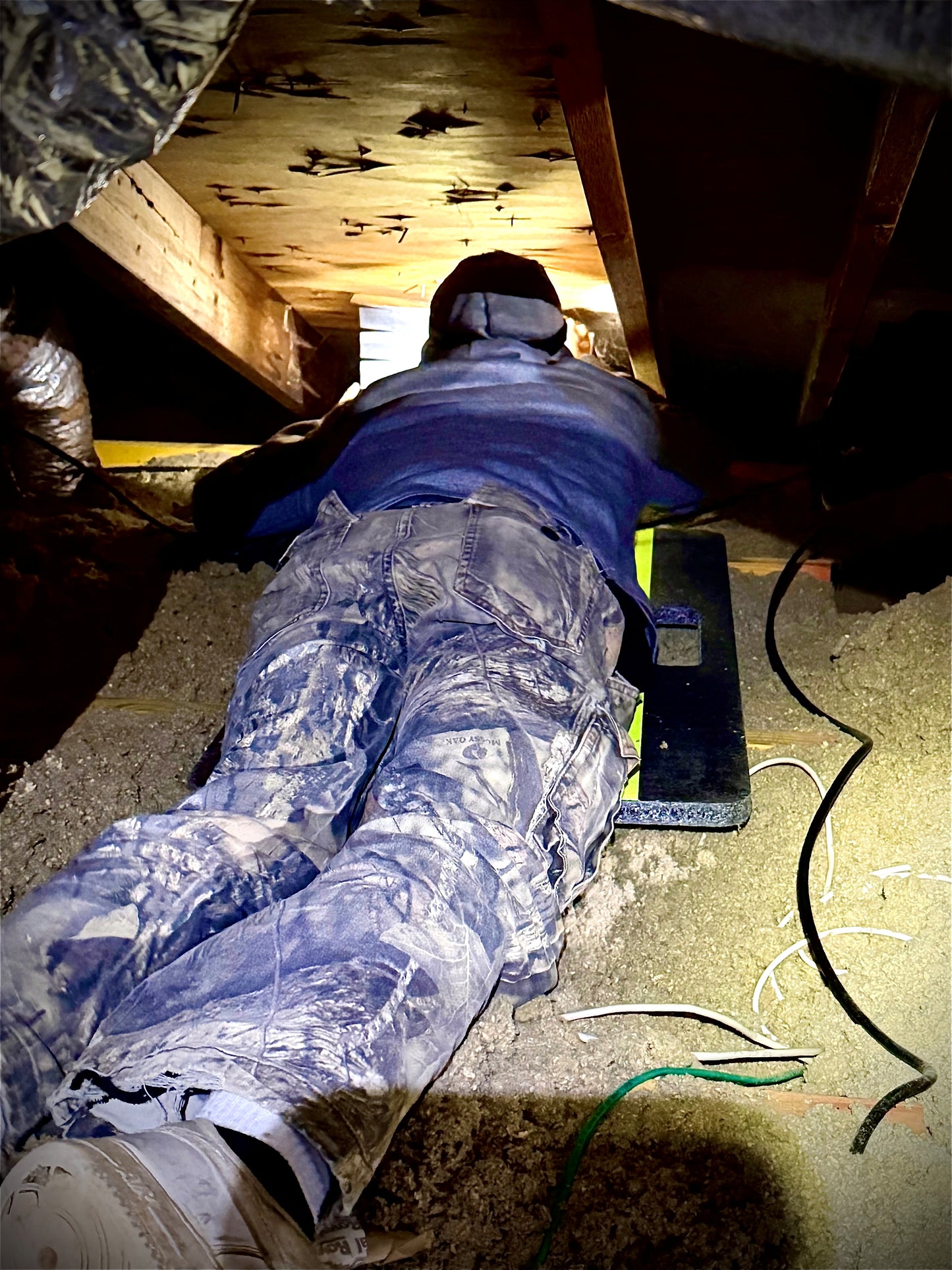 insulation contractor performing work on an attic safety board